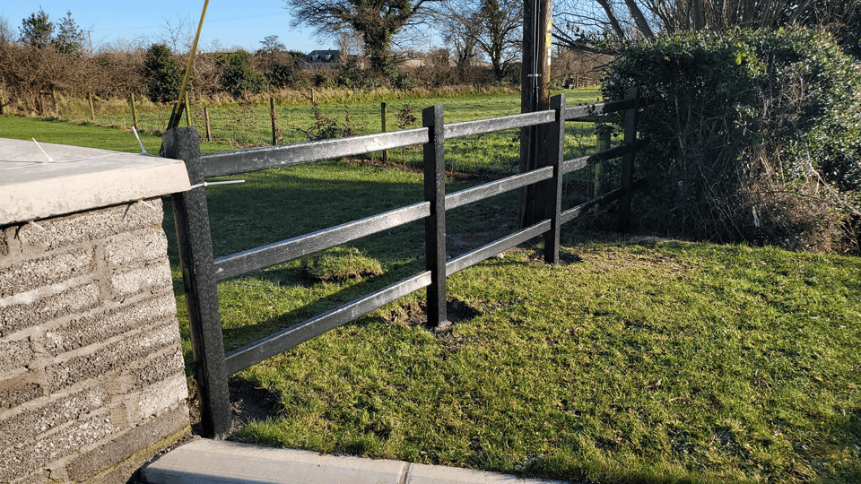plastic fence installed in a garden beside a stone gate pillar plastic fence installed in a garden beside a stone gate pillar