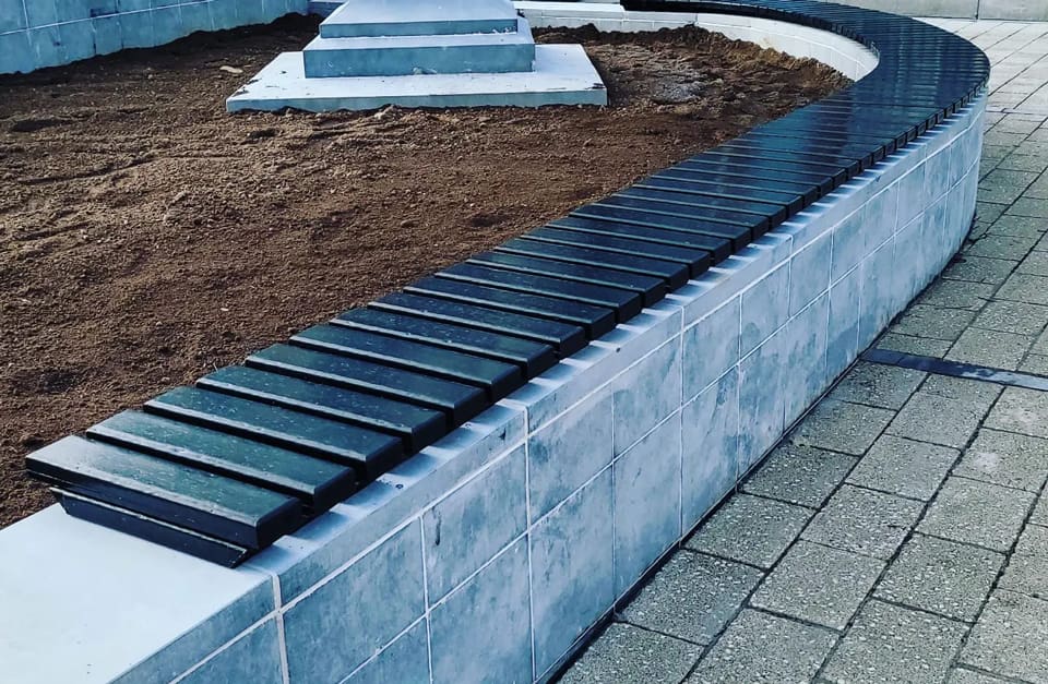 Plastic bench on street concrete base Plastic bench on street concrete base