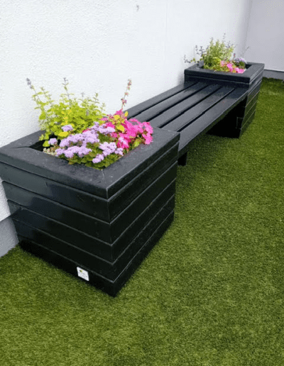 Recycled Plastic Planters Next Generation Plastics NGP bench on astroturf with flowers planted