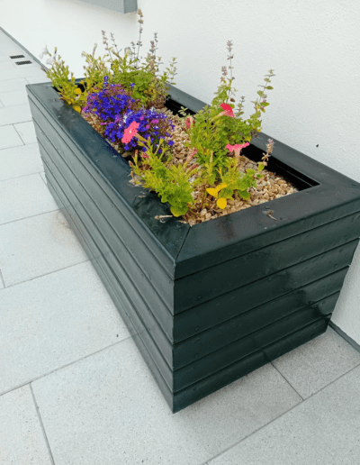 Recycled Plastic Planters Next Generation Plastics NGP with summer flowers blooming in Ireland