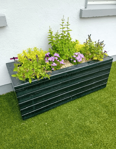 Recycled Plastic Planters Next Generation Plastics NGP rectangle planter with flowers outdoors